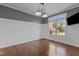Formal dining room featuring wainscoting, hardwood floors, modern lighting, and ample natural light at 5408 Colonial Oaks Dr, Apex, NC 27539