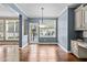 This light-filled dining room has access to the kitchen and backyard, featuring hardwood floors at 5408 Colonial Oaks Dr, Apex, NC 27539