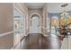 Elegant foyer with hardwood floors and a graceful arched entryway with views to the dining room at 5408 Colonial Oaks Dr, Apex, NC 27539