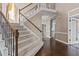 Spacious foyer with a staircase and hardwood floors, leading to a glimpse of the home's interior at 5408 Colonial Oaks Dr, Apex, NC 27539
