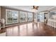 Bright living room with hardwood floors and large windows offering views of the outdoor pool and landscaping at 5408 Colonial Oaks Dr, Apex, NC 27539