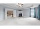 Spacious main bedroom with a tray ceiling, fireplace, plush carpet, and access to an adjoining bathroom at 5408 Colonial Oaks Dr, Apex, NC 27539