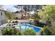Gorgeous swimming pool with lush green landscaping and a white fence surrounding the backyard at 5408 Colonial Oaks Dr, Apex, NC 27539