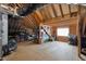 Unfinished attic space with exposed wooden beams and plywood subflooring, providing ample storage or renovation potential at 5733 Mizuno Dr, Fuquay Varina, NC 27526