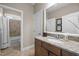 Granite countertop vanity with view of tub and tiled shower/tub in this well-lit full bathroom at 5733 Mizuno Dr, Fuquay Varina, NC 27526