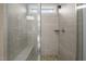 Modern bathroom featuring a tiled shower with a glass door, bench, and pebble flooring accent at 5733 Mizuno Dr, Fuquay Varina, NC 27526