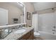 Well-lit bathroom with a granite-topped vanity, modern fixtures, and a shower-tub combination with a white shower curtain at 5733 Mizuno Dr, Fuquay Varina, NC 27526