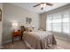 Comfortable bedroom features a ceiling fan, a large window, and cozy decor at 5733 Mizuno Dr, Fuquay Varina, NC 27526