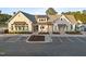 Aerial shot of a clubhouse featuring well-manicured landscaping and ample parking spaces at 5733 Mizuno Dr, Fuquay Varina, NC 27526