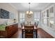 Formal dining room with hardwood floors, chandelier, and wainscoting at 5733 Mizuno Dr, Fuquay Varina, NC 27526
