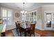 Elegant dining room with hardwood floors, plantation shutters, and decorative chandelier at 5733 Mizuno Dr, Fuquay Varina, NC 27526