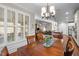 Open-concept dining room with hardwood floors and views into the kitchen and living room at 5733 Mizuno Dr, Fuquay Varina, NC 27526