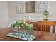 Well-lit dining room featuring hardwood flooring, decorative wall art, and a table centerpiece at 5733 Mizuno Dr, Fuquay Varina, NC 27526