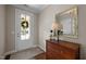 Bright foyer with a decorative mirror, wooden dresser, and a view of the front door at 5733 Mizuno Dr, Fuquay Varina, NC 27526