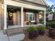 Inviting front porch with brick pillars, bench seating, and tasteful landscaping at 5733 Mizuno Dr, Fuquay Varina, NC 27526