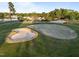 Aerial photograph displays a golf course with sand bunker near a clubhouse and lake at 5733 Mizuno Dr, Fuquay Varina, NC 27526