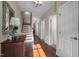 Hallway features hardwood floors, white trim, and staircase at 5733 Mizuno Dr, Fuquay Varina, NC 27526