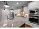 Gourmet kitchen features a central island, granite countertops, and stainless steel appliances at 5733 Mizuno Dr, Fuquay Varina, NC 27526