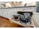Detailed view of kitchen cabinet with pull out storage containing various pots and pans at 5733 Mizuno Dr, Fuquay Varina, NC 27526