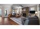 Comfortable living room showcasing a stone fireplace, hardwood floors, and natural light at 5733 Mizuno Dr, Fuquay Varina, NC 27526