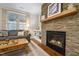 Inviting living room with a stone fireplace, wood floors, and comfortable seating area at 5733 Mizuno Dr, Fuquay Varina, NC 27526