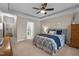 A bright main bedroom with tray ceiling, with an open ensuite bathroom and hallway at 5733 Mizuno Dr, Fuquay Varina, NC 27526