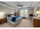 Spacious main bedroom with a tray ceiling, fan, and large window providing ample natural light at 5733 Mizuno Dr, Fuquay Varina, NC 27526