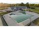Aerial view of a community pool with diving blocks, surrounded by manicured landscaping and a clubhouse at 5733 Mizuno Dr, Fuquay Varina, NC 27526