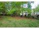This private back yard is lined with mature trees at 5911 Mountain Island Dr, Durham, NC 27713
