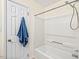 Bright bathroom with a shower-tub and a blue towel hanging on the door at 5911 Mountain Island Dr, Durham, NC 27713