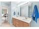 Bright bathroom featuring double sinks, a large mirror, and stylish fixtures at 5911 Mountain Island Dr, Durham, NC 27713
