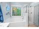 Bright bathroom featuring a soaking tub with a window and a glass enclosed shower at 5911 Mountain Island Dr, Durham, NC 27713
