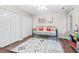Comfortable bedroom featuring a daybed, closet, and hardwood floors at 5911 Mountain Island Dr, Durham, NC 27713