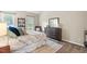 Comfortable bedroom with neutral tones, plush bedding, and large dresser at 5911 Mountain Island Dr, Durham, NC 27713