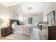 Bright bedroom featuring vaulted ceilings, skylight, and comfortable furnishings at 5911 Mountain Island Dr, Durham, NC 27713