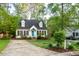 Charming home with a black roof and a bright turquoise front door at 5911 Mountain Island Dr, Durham, NC 27713