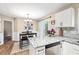 Eat-in kitchen with stainless appliances, granite countertops, and table with seating for four at 5911 Mountain Island Dr, Durham, NC 27713