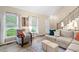 Beautiful living room featuring a fireplace, built-in shelving, large windows, and comfortable seating at 5911 Mountain Island Dr, Durham, NC 27713