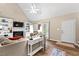 Comfortable living room featuring a fireplace, built-in shelves, large windows, and luxury vinyl plank flooring at 5911 Mountain Island Dr, Durham, NC 27713