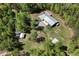 Wide aerial view shows the home, sheds, gardens, and wooded lot at 605 Faucette Mill Rd, Hillsborough, NC 27278