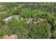 Scenic aerial view showcasing lush greenery, outbuildings, and serene landscape of the property at 605 Faucette Mill Rd, Hillsborough, NC 27278