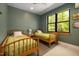 Comfortable bedroom with twin beds, a large window offering natural light, and scenic views at 605 Faucette Mill Rd, Hillsborough, NC 27278