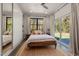 Sunlit bedroom with a view of the backyard, complemented by a modern ceiling fan at 605 Faucette Mill Rd, Hillsborough, NC 27278
