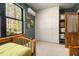 Charming bedroom with built-in storage, a large window, and serene views of the surrounding landscape at 605 Faucette Mill Rd, Hillsborough, NC 27278
