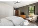 Relaxing bedroom with a large window, built-in wardrobe, and view of the outdoors at 605 Faucette Mill Rd, Hillsborough, NC 27278