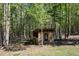 Wood constructed chicken coop nestled amongst mature trees at 605 Faucette Mill Rd, Hillsborough, NC 27278