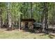 Well-maintained chicken coop surrounded by trees at 605 Faucette Mill Rd, Hillsborough, NC 27278