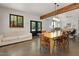 Open dining space with hardwood floors, wooden table, and stylish seating with views to the outdoors at 605 Faucette Mill Rd, Hillsborough, NC 27278