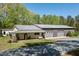 Beautiful exterior featuring white siding, metal roof, covered porch with swing, and an attached garage at 605 Faucette Mill Rd, Hillsborough, NC 27278