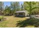 Charming backyard building featuring a screened-in porch and a well-maintained lawn, perfect for outdoor relaxation at 605 Faucette Mill Rd, Hillsborough, NC 27278